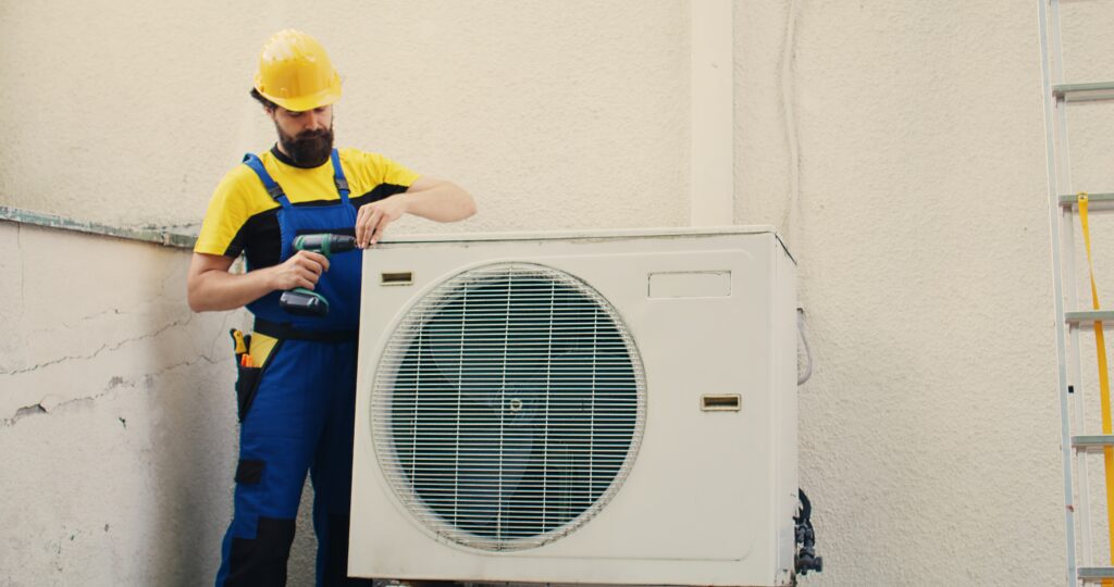 Expert wireman works on air conditioner